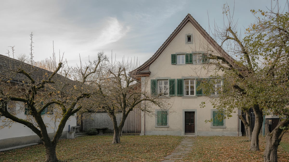 Family house with green shutters in an old orchard